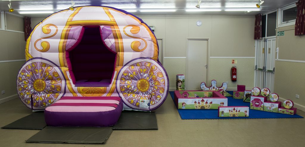 a princess carriage style bouncy castle and soft play set.