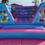 an 8ft minnie and mickey themed castle in pink and purple