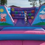 an 8ft peppa pig themed castle in pink and purple