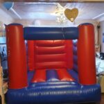 a red and blue cpompact bouncy castle