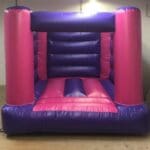 a pink and purple compact bouncy castle