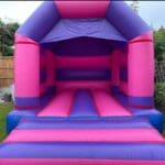 a bouncy castle decorated in pink and purple