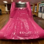 a shiny pink obstacle course showing the slide