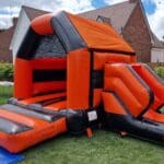 A orange black shiny themed castle with slide side view